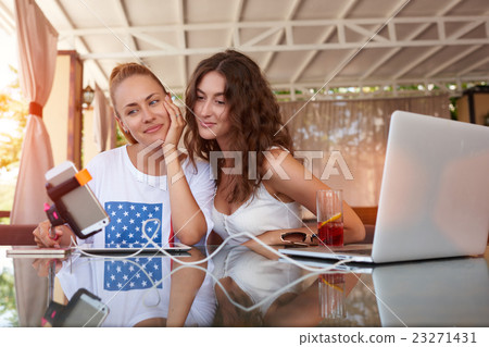 Charming hipster girls making photo on telephone 23271431