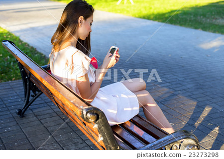 Beautiful brunette girl writing a message phone 23273298