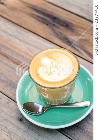 Coffee latte art on wooden table 23277410