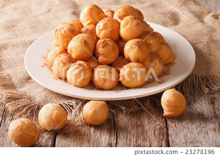 Small donuts with honey and cinnamon on the table 23278196