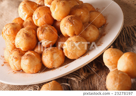 Greek dessert loukoumades with honey and cinnamon Greek dessert loukoumades with honey and cinnamon 23278197
