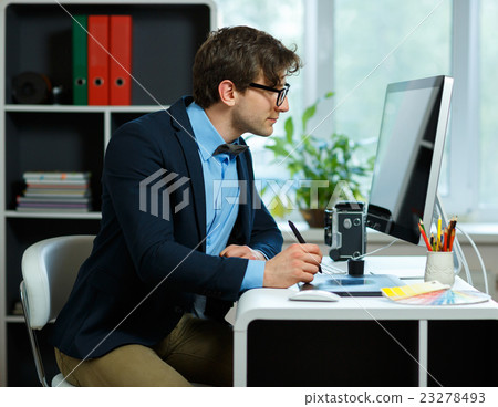 Handsome young man working from home office Handsome young man working from home office 23278493