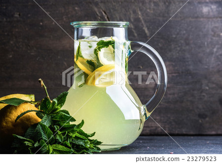 Homemade lemonade with mint, lemon slices and ice Homemade lemonade with mint, lemon slices and ice 23279523