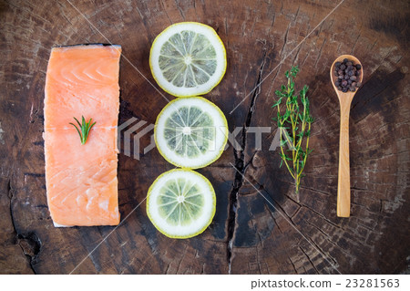 A piece of rare salmon with herb on wooden board A piece of rare salmon with herb on wooden board 23281563