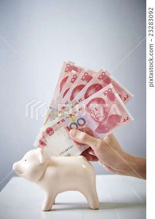 Chinese Yuan Renminbi Banknotes and pig's piggy bank Chinese Yuan Renminbi Banknotes and pig's piggy bank 23283092