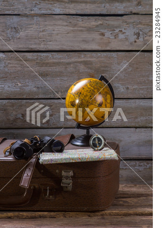 Globe and compass on suitcase. 23284945