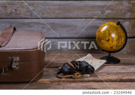 Globe with map and binoculars. 23284946