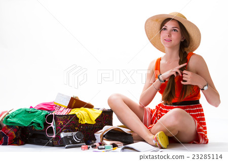 Sitting girl near overfilled suitcase. Sitting girl near overfilled suitcase. 23285114