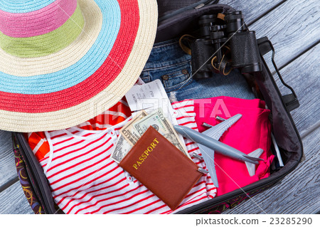 Suitcase with clothes and binoculars. Suitcase with clothes and binoculars. 23285290