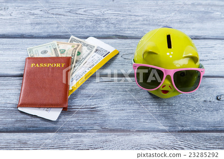 Brown passport and money box. 23285292