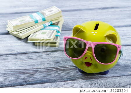 Lime piggy bank in sunglasses. Lime piggy bank in sunglasses. 23285294