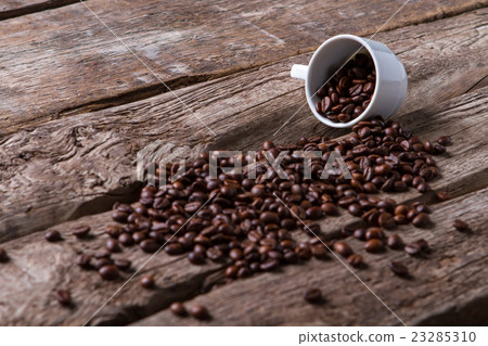 Roasted coffee beans and cup. Roasted coffee beans and cup. 23285310