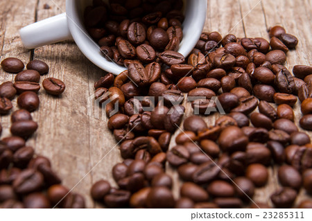 Cup with roasted coffee beans. Cup with roasted coffee beans. 23285311