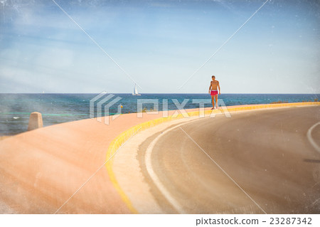 Young sports guy, on background Sailboats floating Young sports guy, on background Sailboats floating 23287342