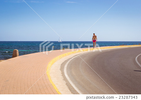 Young sports guy, on background Sailboats floating Young sports guy, on background Sailboats floating 23287343