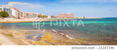 Sunny Mediterranean beach, Tourists relax on sand 23287346