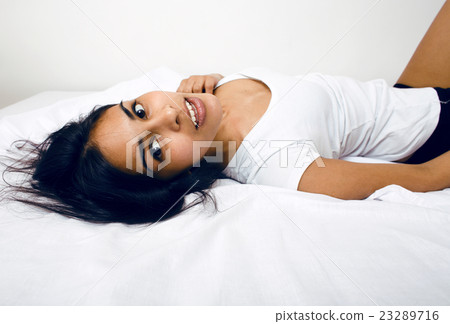 pretty indian brunette real woman in bed smiling pretty indian brunette real woman in bed smiling 23289716