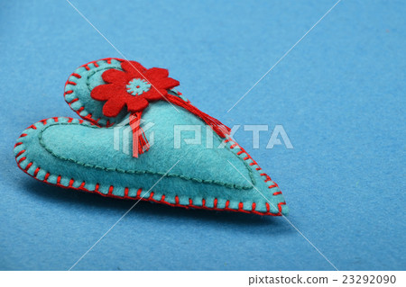 Felt craft and art teal heart with flower on blue Felt craft and art teal heart with flower on blue 23292090