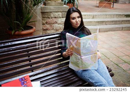 Young Asian brunette hair woman holding a map Young Asian brunette hair woman holding a map 23292245