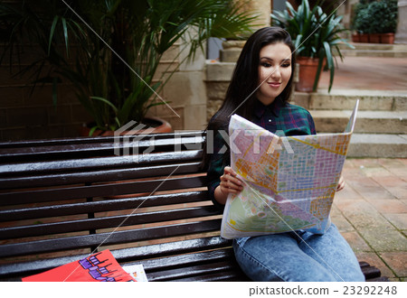 Brunette hair tourist girl enjoying her vacation Brunette hair tourist girl enjoying her vacation 23292248