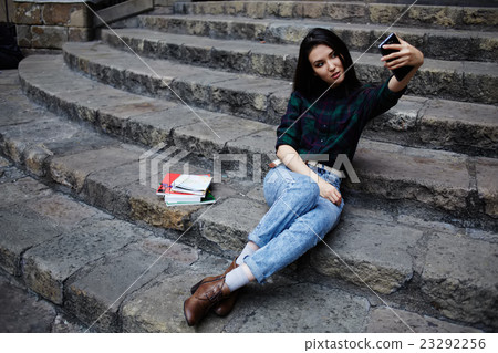 Hipster girl photographing herself with phone Hipster girl photographing herself with phone 23292256