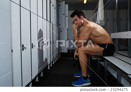 Young sportsman is resting after hard training Young sportsman is resting after hard training 23294275