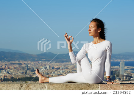 Woman makes yoga on mountain hill Woman makes yoga on mountain hill 23294592
