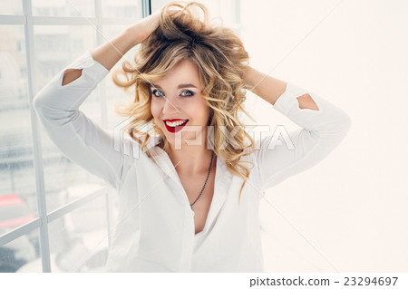 Girl smiling at camera in a white shirt Girl smiling at camera in a white shirt 23294697