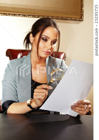woman looks on to document 23295735