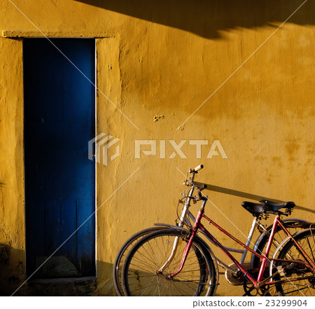 Couple of bicycle on old wall background 23299904