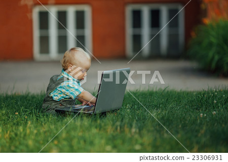 little boy with laptop on grass little boy with laptop on grass 23306931