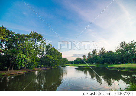 Green grass in public park with pond background. Green grass in public park with pond background. 23307726