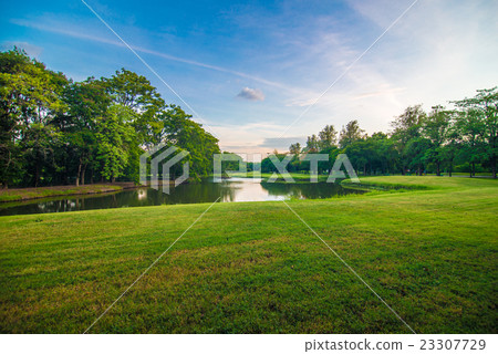 Green grass in public park with pond background. Green grass in public park with pond background. 23307729