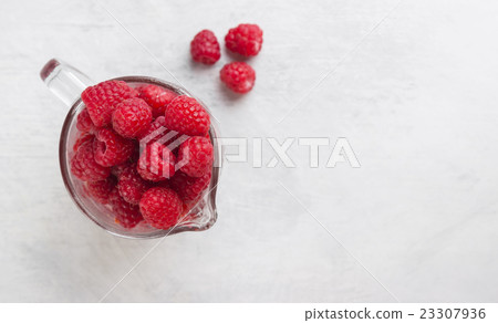 Red raspberry in cups on a white background Red raspberry in cups on a white background 23307936