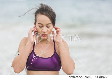 Female runner preparing for outdoor workout on the Female runner preparing for outdoor workout on the 23308729