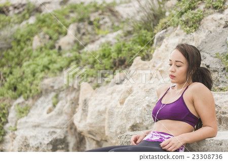 Fitness Woman resting after work out on the beach Fitness Woman resting after work out on the beach 23308736