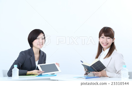 A woman operating with a tablet A woman operating with a tablet 23310544