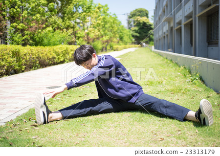 A man stretching on the grass 23313179
