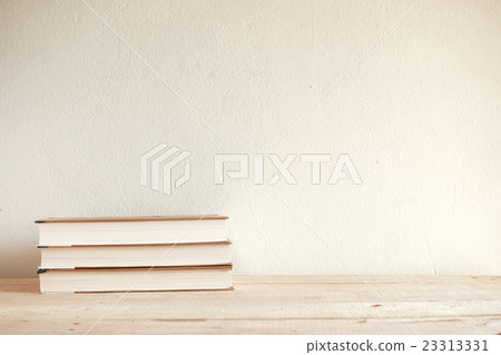 Book on wood table - vintage style tone Book on wood table - vintage style tone 23313331