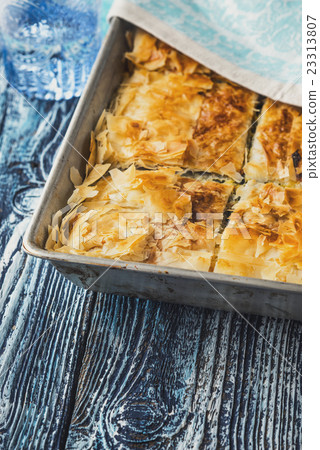 Greek pie spanakopita in the metal pan on table Greek pie spanakopita in the metal pan on table 23313807