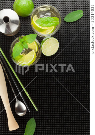 Mojito cocktail and ingredients over rubber mat 23314033