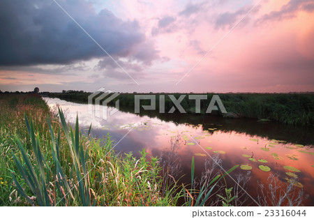 rainy sunset over river 23316044