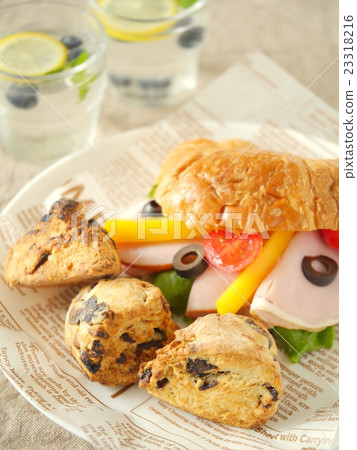 Prune scone and croissant sand brown background (high angle) 23318216