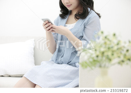 A woman operating a smartphone 23319872