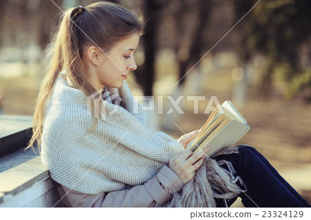 girl in autumn park with a book 23324129
