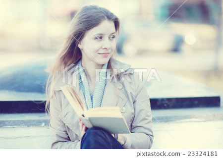 girl in autumn park with a book 23324181