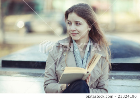 girl in autumn park with a book 23324196