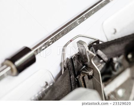 side view of typebar hits ink ribbon in typewriter 23329020