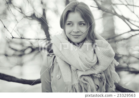monochrome urban portrait of a woman in a coat 23329563