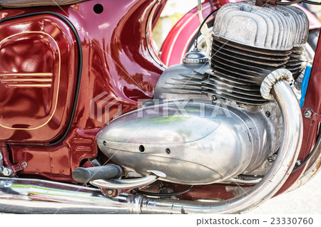 Detail of red veteran motorbike, meeting bikers Detail of red veteran motorbike, meeting bikers 23330760